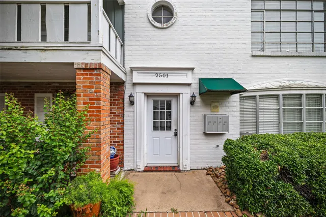 a front view of a house with plants