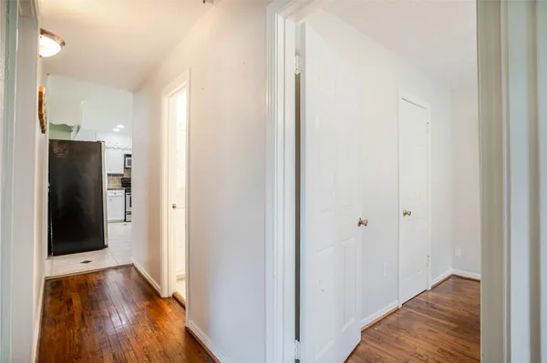 a view of hallway with wooden floor