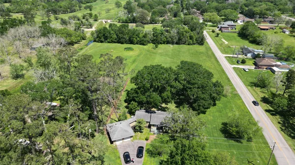 an aerial view of residential houses with outdoor space and street view