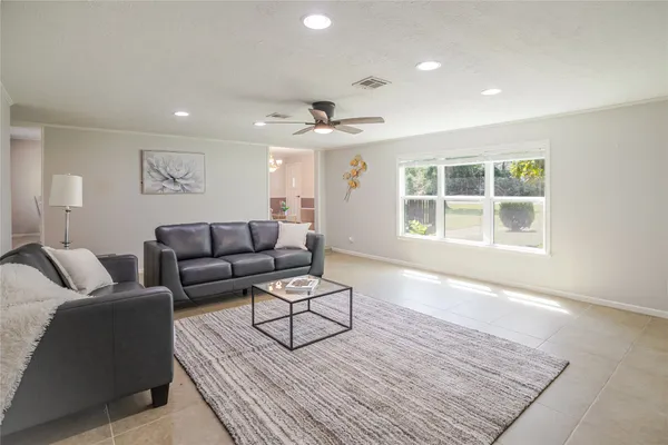 a living room with furniture and windows