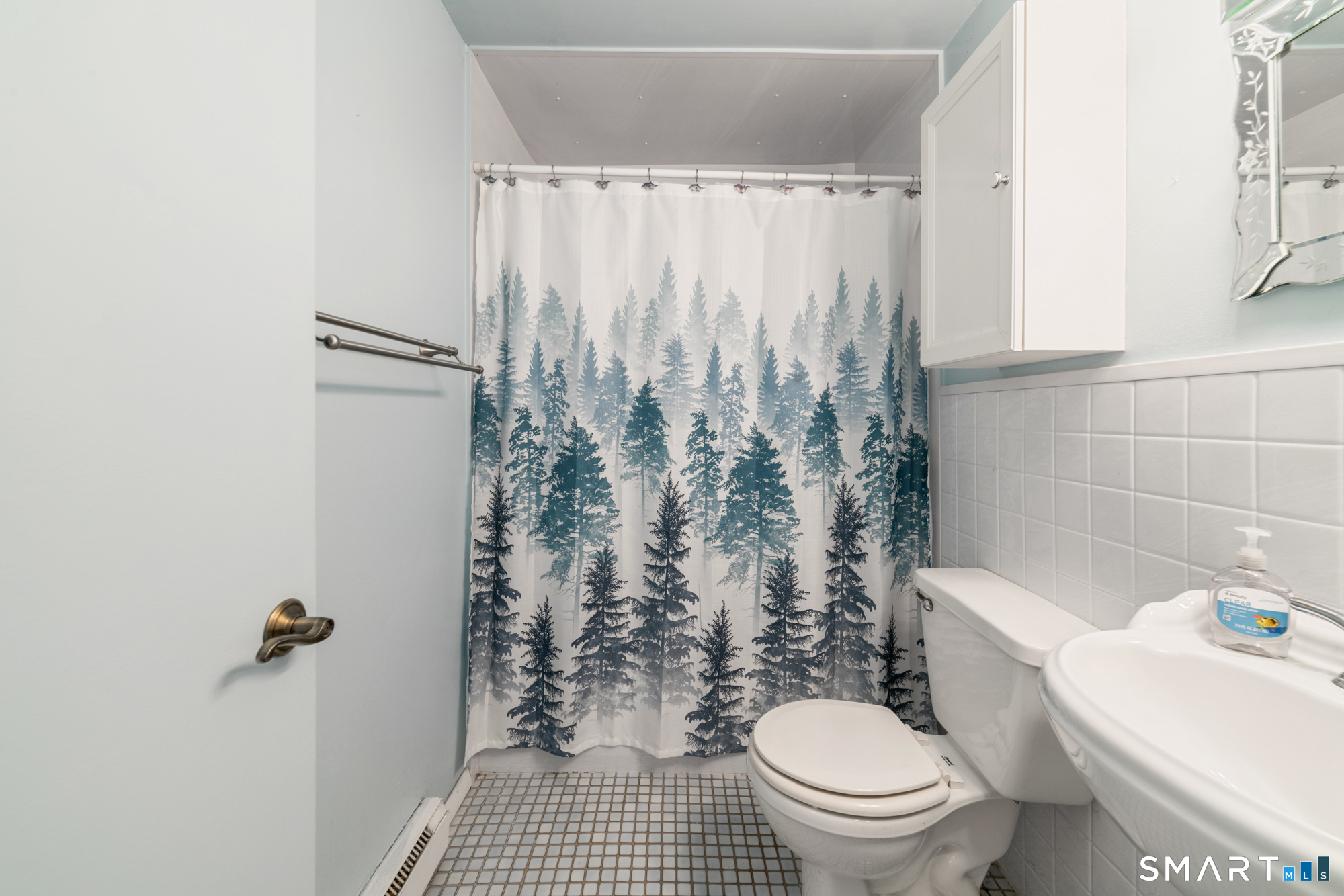 55 Porter Avenue, Unit 6E Naugatuck, CT 06770 - Photo 16 of 29 a white toilet sitting next to a shower curtain