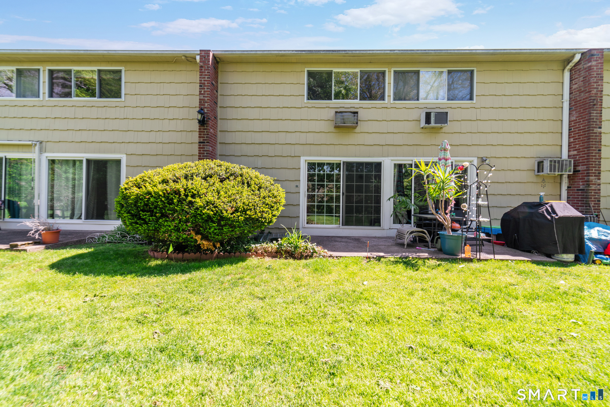 55 Porter Avenue, Unit 6E Naugatuck, CT 06770 - Photo 3 of 29 a view of a house with a backyard and a patio