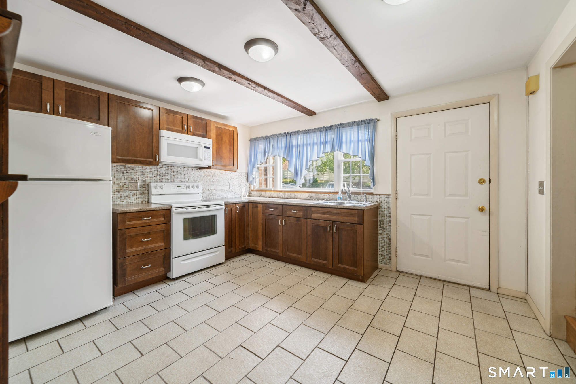 55 Porter Avenue, Unit 6E Naugatuck, CT 06770 - Photo 7 of 29 a kitchen with stainless steel appliances a stove sink and cabinets