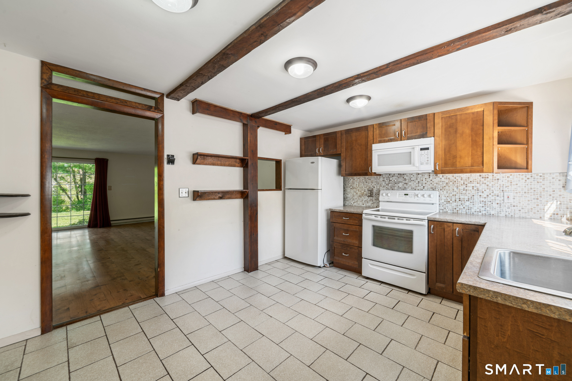 55 Porter Avenue, Unit 6E Naugatuck, CT 06770 - Photo 9 of 29 a kitchen with stainless steel appliances granite countertop a refrigerator and a stove
