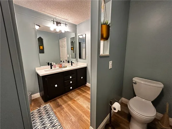 a bathroom with a toilet sink and mirror