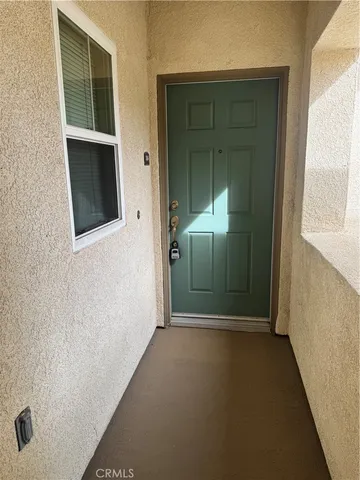 a view of a hallway with wooden door