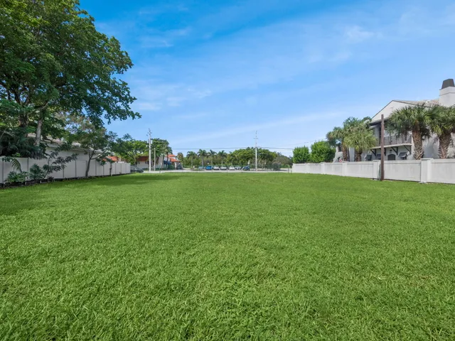 a view of a field of grass and trees