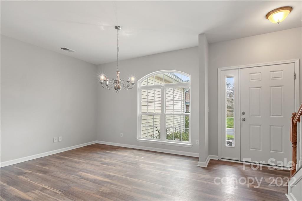 272 Lorraine Road Fort Mill, SC 29708 - Photo 10 of 42 an empty room with wooden floor exposed radiator and windows