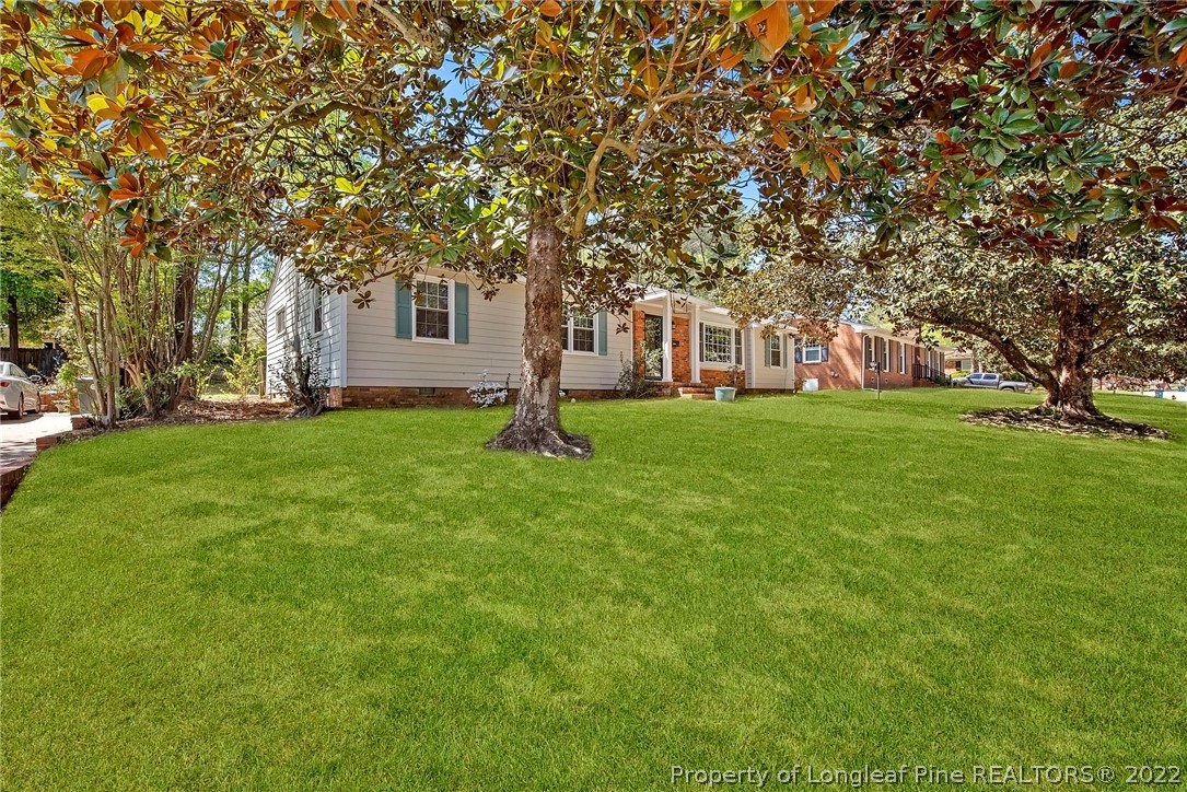 2611 Huntington Road Fayetteville, NC 28303 - Photo 2 of 33 a brick house with a big yard and large trees