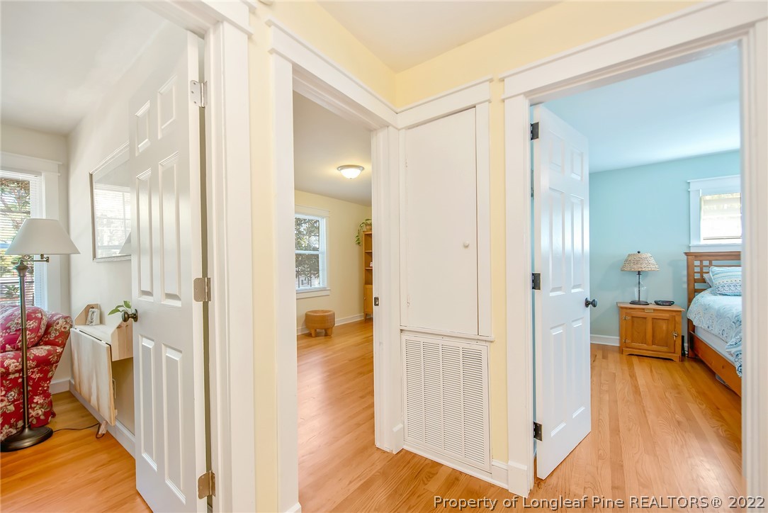 2611 Huntington Road Fayetteville, NC 28303 - Photo 21 of 33 a view of a hallway with bathroom and wooden floor