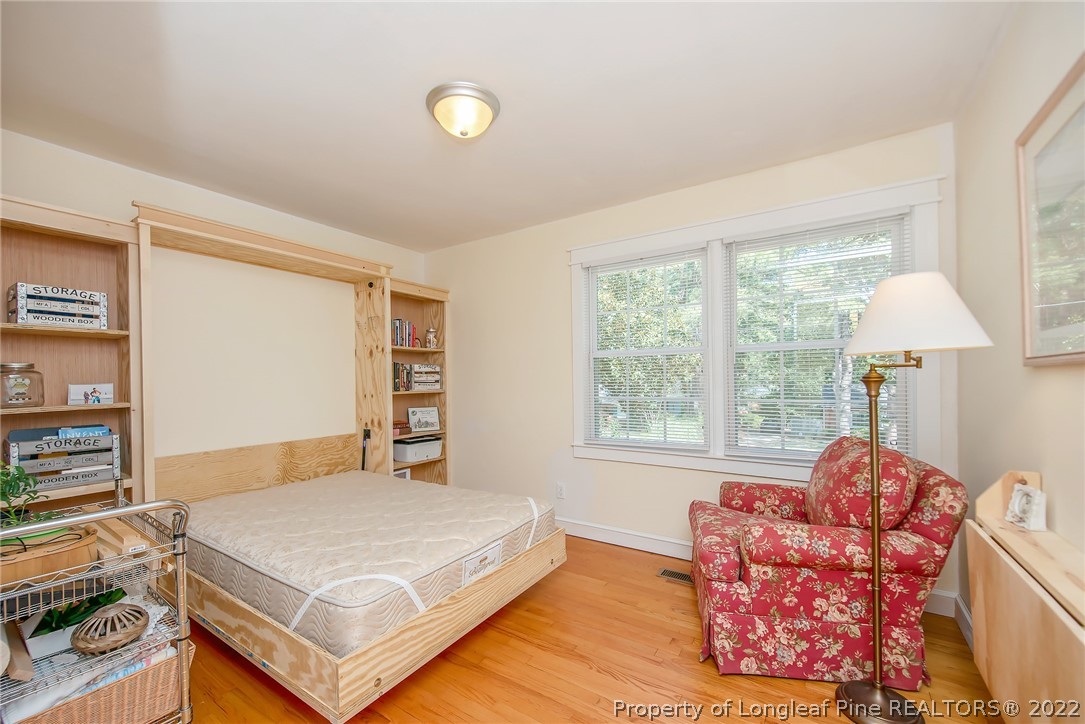 2611 Huntington Road Fayetteville, NC 28303 - Photo 28 of 33 a bedroom with a bed and wooden floor