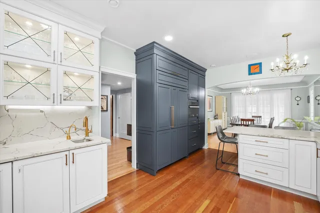 a view of an entryway with wooden floor and cabinets