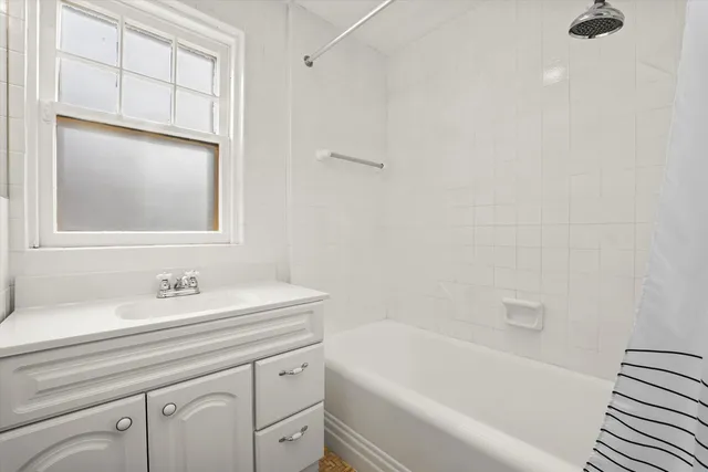 a bathroom with a granite countertop toilet sink and mirror