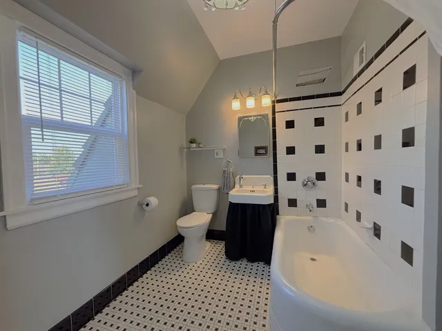 a bathroom with a sink toilet and a mirror