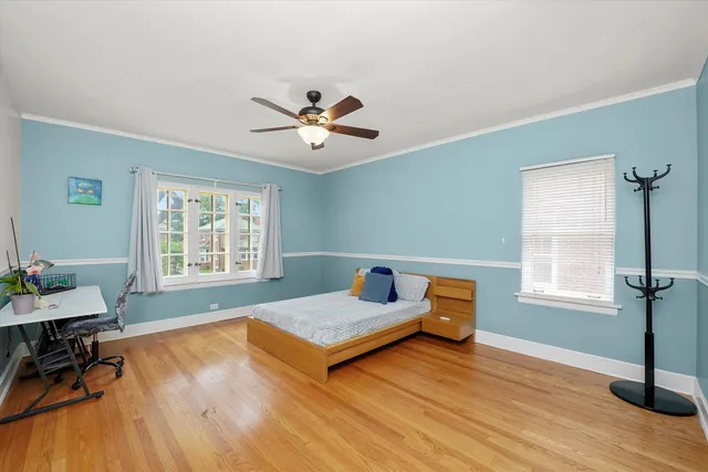 a bedroom with furniture and wooden floor