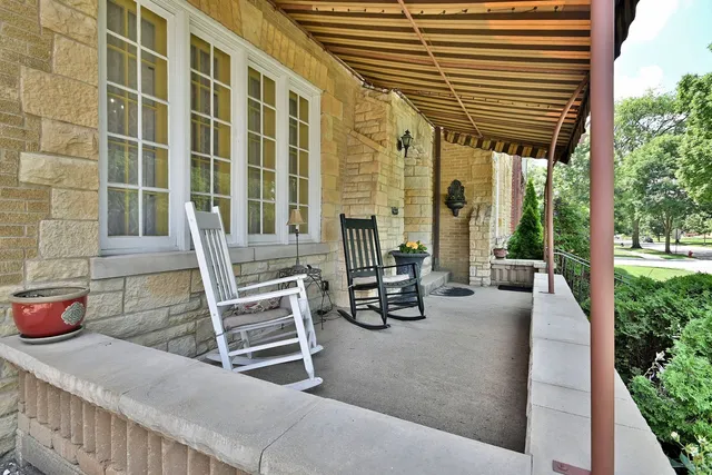 a view of a patio with a dining table and chairs with wooden floor and fence