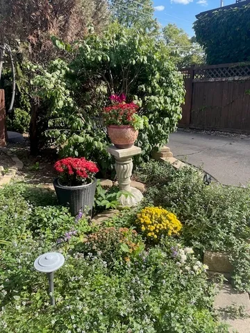 a front view of a house with a garden and patio