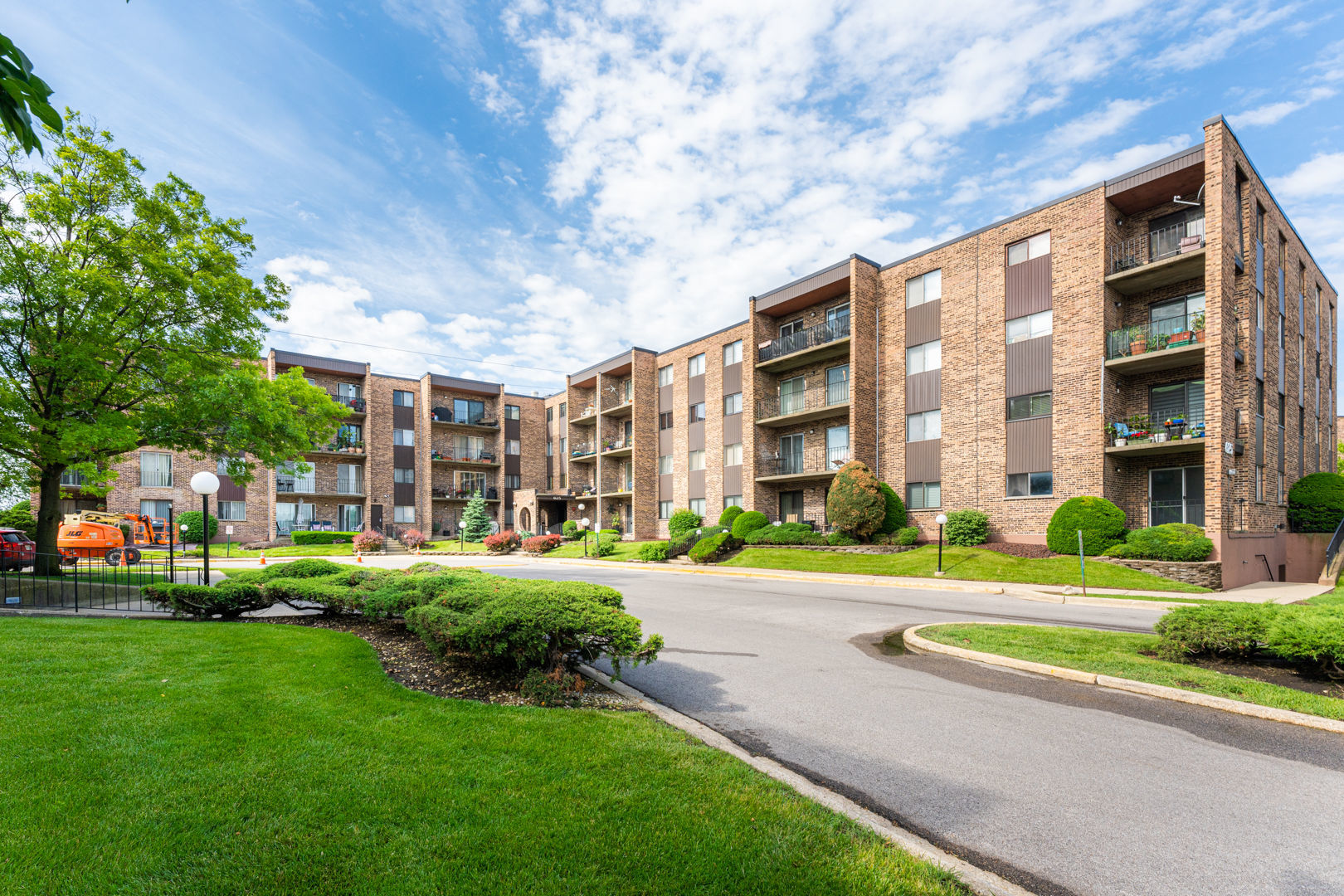 625 West Huntington Commons Road, Unit 106 Mount Prospect, IL 60056 - Photo 1 of 17 a view of a building with a yard