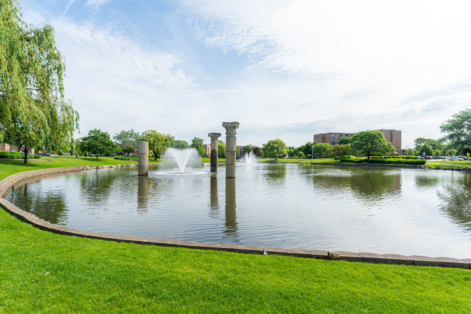 625 West Huntington Commons Road, Unit 106 Mount Prospect, IL 60056 - Photo 13 of 17 a view of a lake with houses in the background