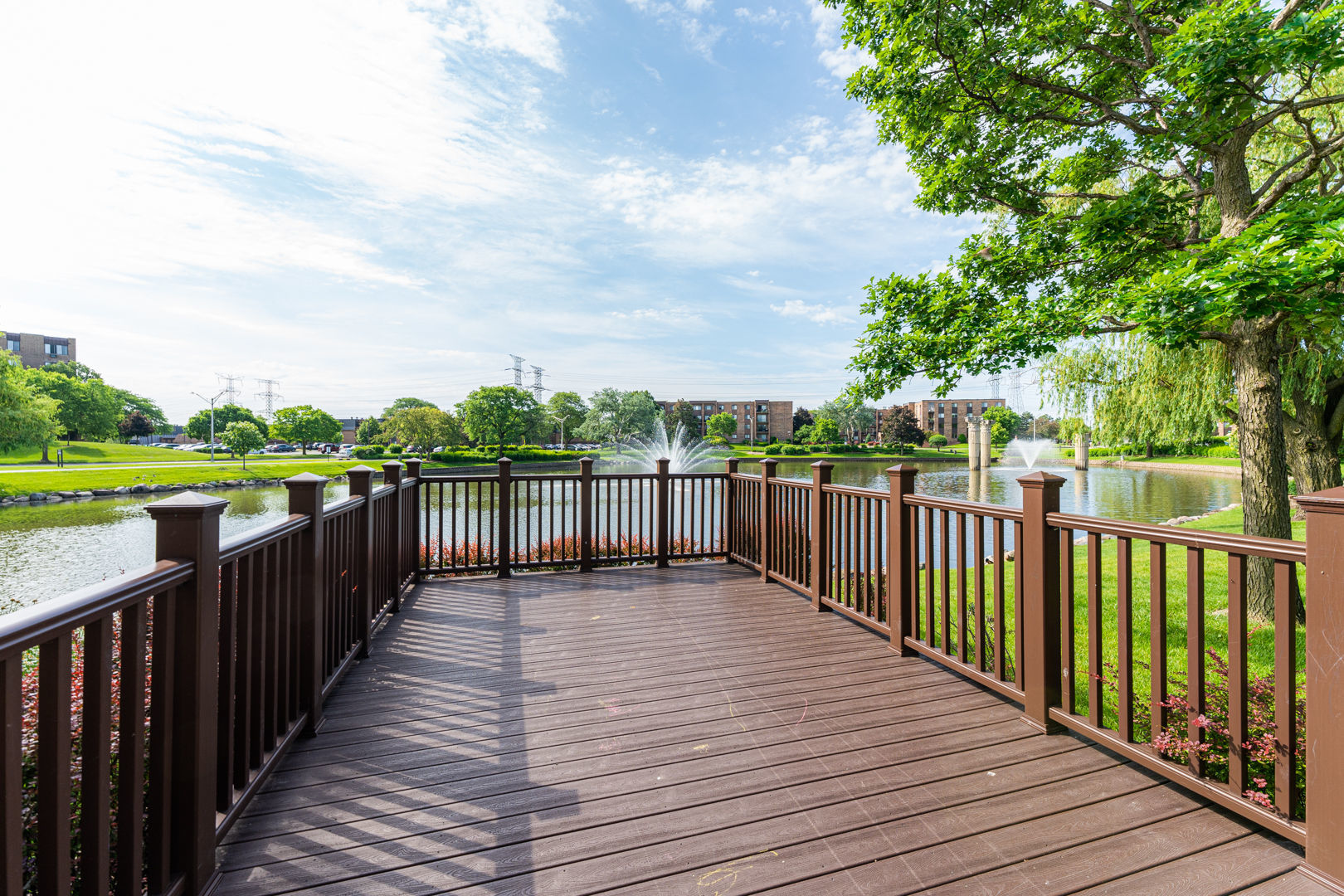 625 West Huntington Commons Road, Unit 106 Mount Prospect, IL 60056 - Photo 17 of 17 a balcony with wooden floor and fence