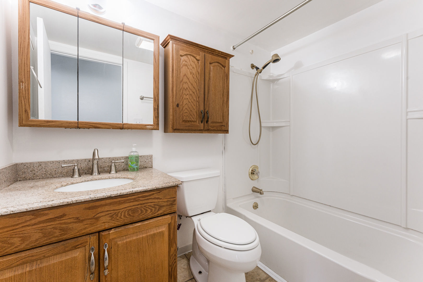 625 West Huntington Commons Road, Unit 106 Mount Prospect, IL 60056 - Photo 10 of 17 a bathroom with a granite countertop sink toilet and shower