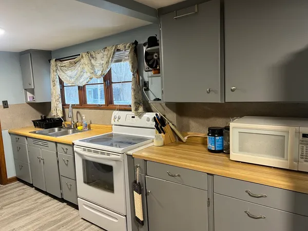 a kitchen with stainless steel appliances granite countertop a sink and a stove