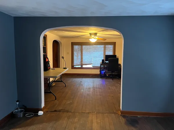 a living room with furniture and a mirror