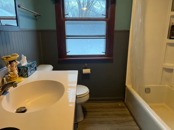 a bathroom with a tub and a window