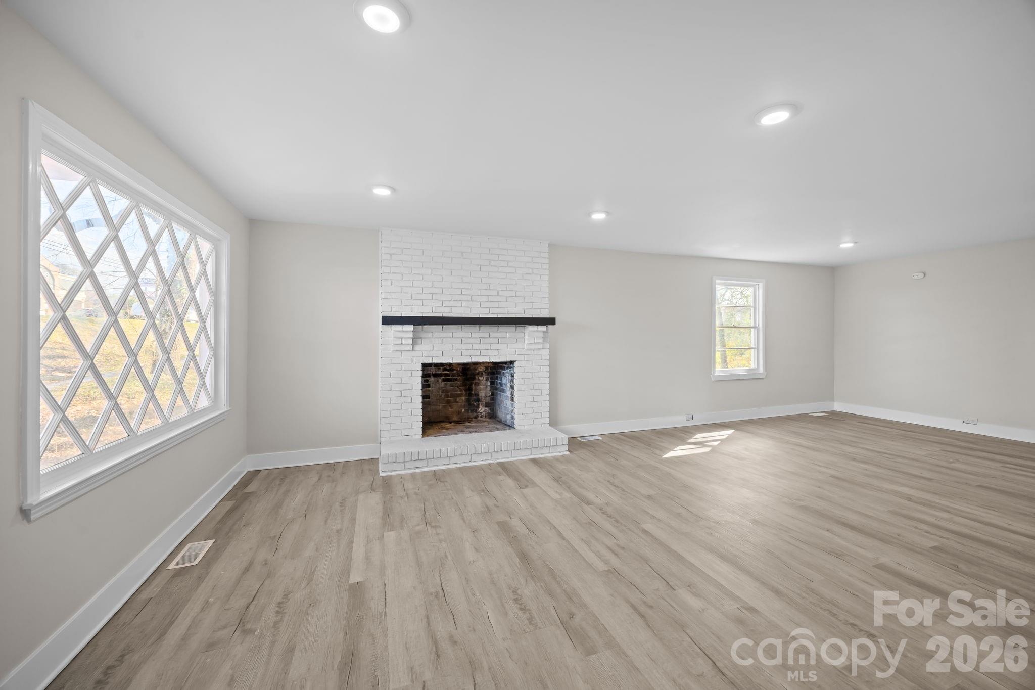 511 East Trade Street Dallas, NC 28034 - Photo 5 of 16 wooden floor in an empty room with a window