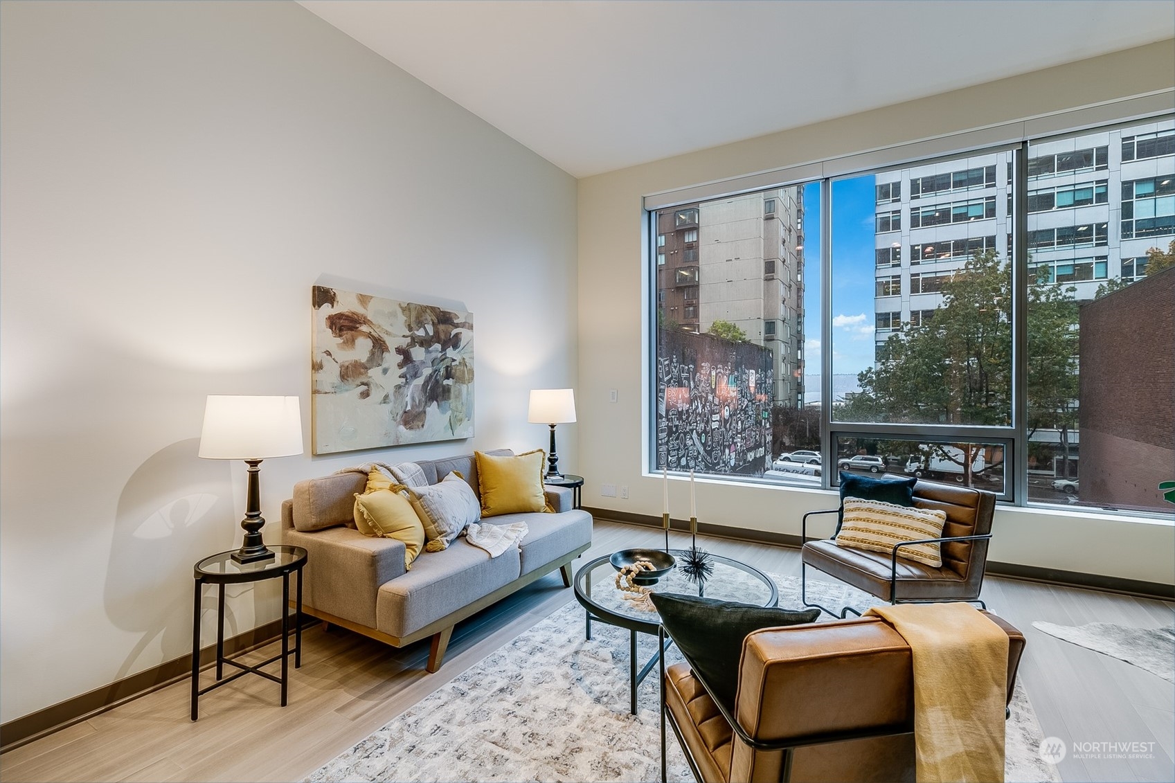 2033 2nd Avenue, Unit 101 Seattle, WA 98121 - Photo 13 of 37 a living room with furniture and a large window