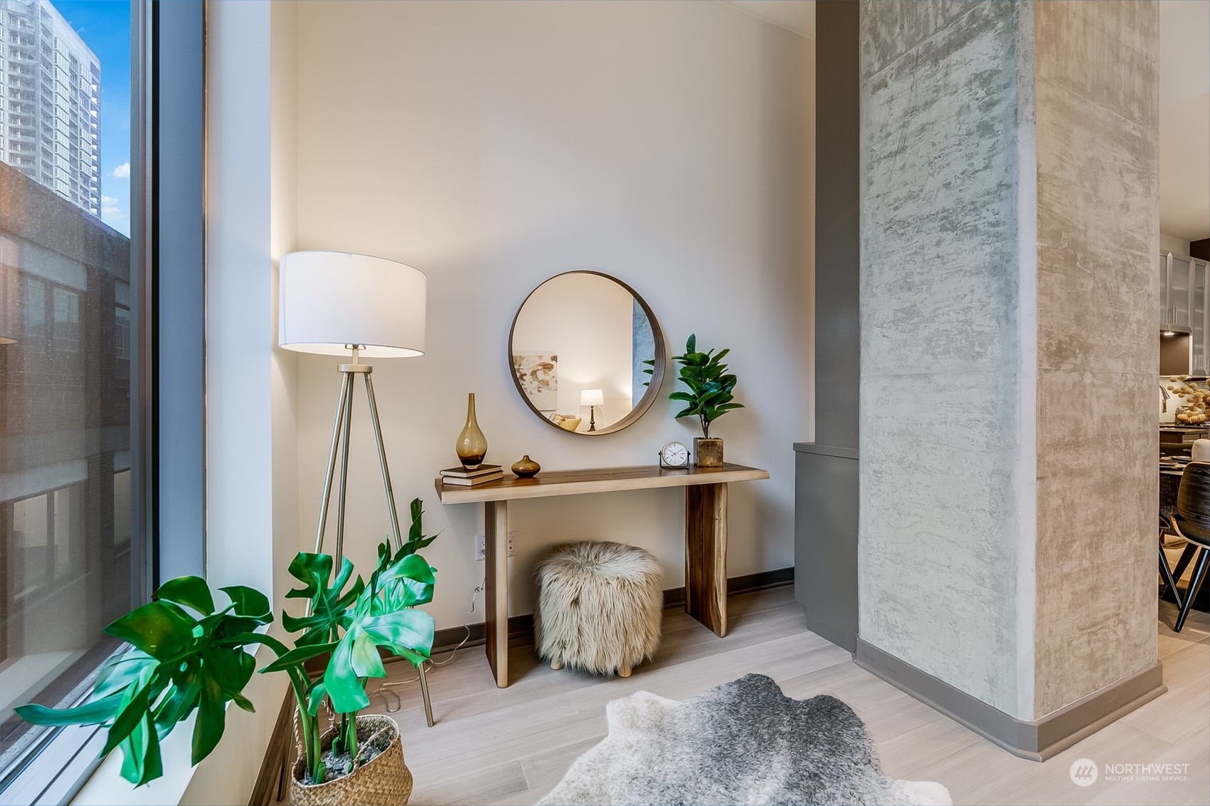 2033 2nd Avenue, Unit 101 Seattle, WA 98121 - Photo 14 of 37 a room with painting on the wall and a potted plant