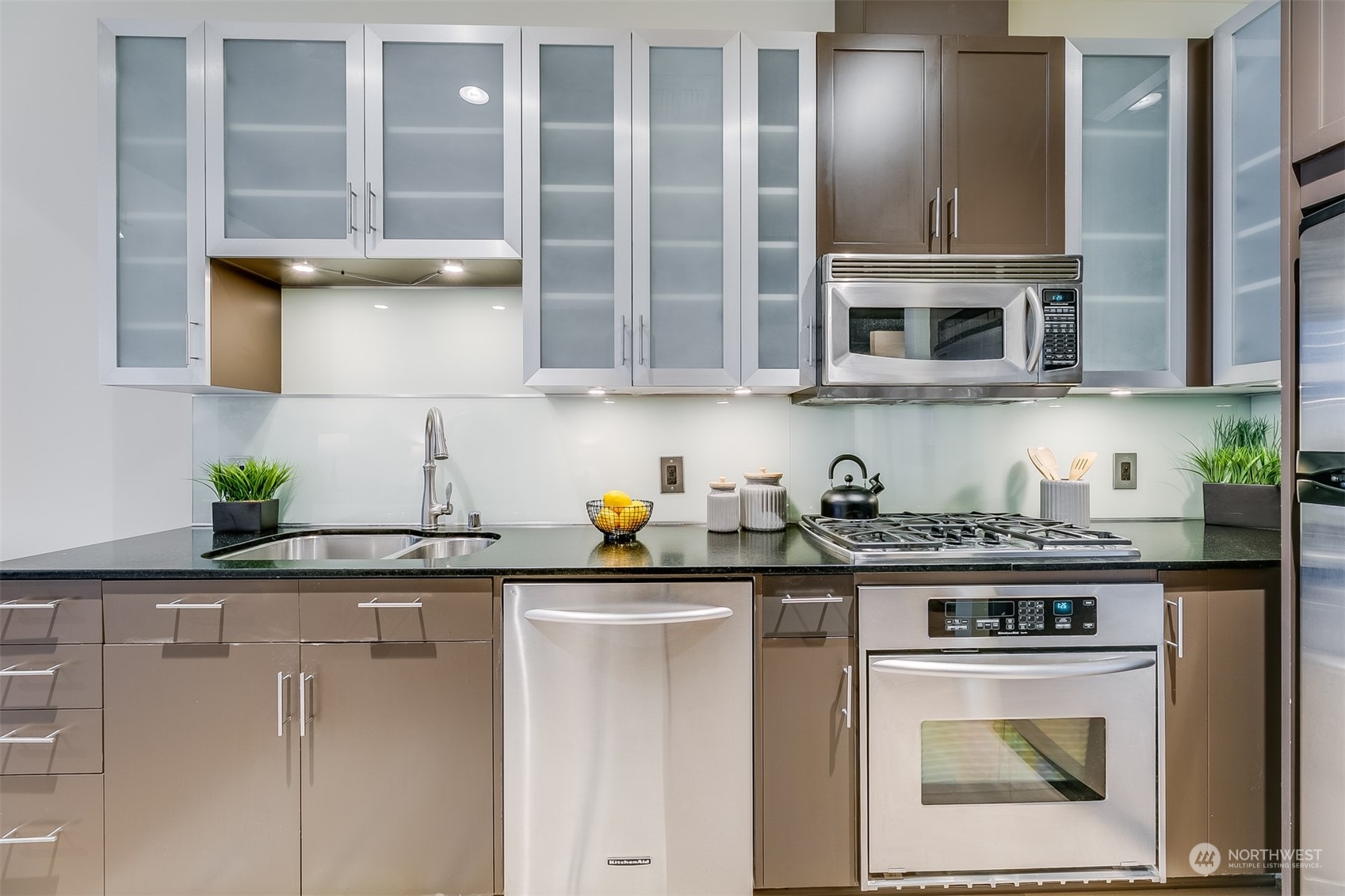 2033 2nd Avenue, Unit 101 Seattle, WA 98121 - Photo 20 of 37 a kitchen with stainless steel appliances granite countertop a stove a sink and a microwave