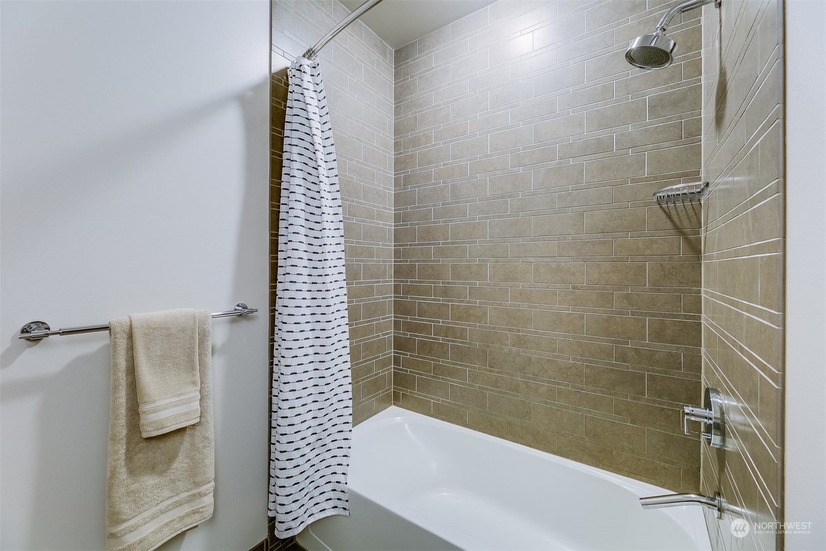 2033 2nd Avenue, Unit 101 Seattle, WA 98121 - Photo 22 of 37 a bathroom with a bathtub and a shower