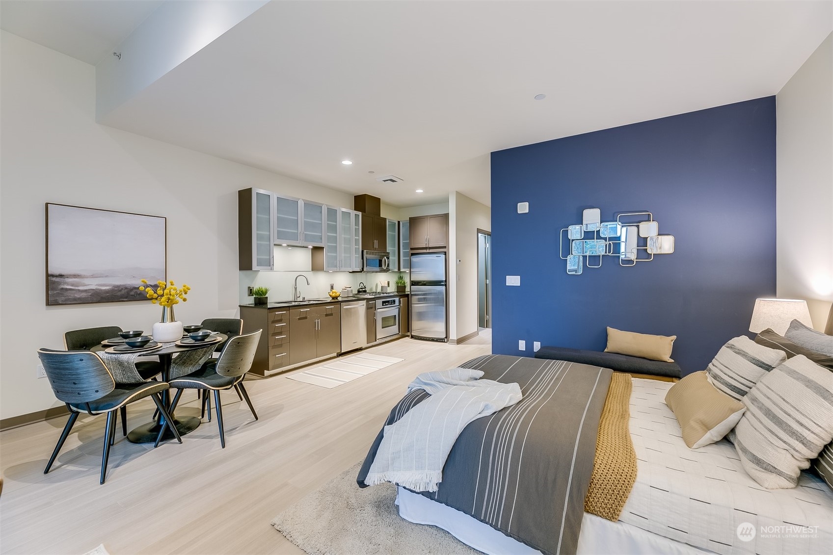 2033 2nd Avenue, Unit 101 Seattle, WA 98121 - Photo 9 of 37 a bedroom with a bed furniture and a chandelier