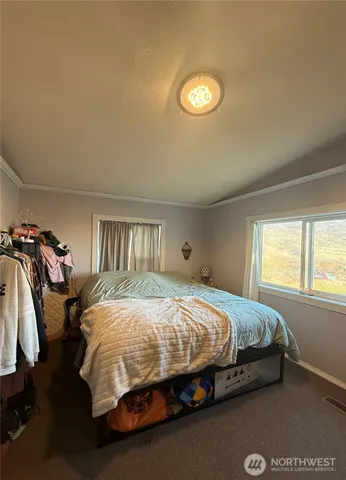 a spacious bedroom with a bed and a window