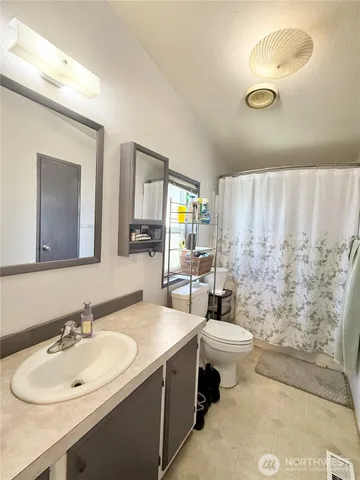 a bedroom with a bed and glass wall