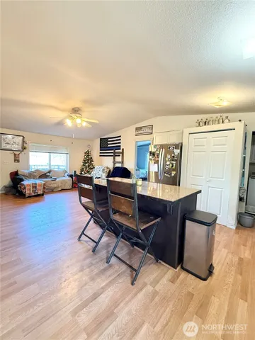 a view of a livingroom with furniture and a kitchen