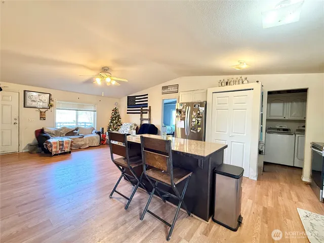a kitchen with stainless steel appliances granite countertop a sink counter space and cabinets