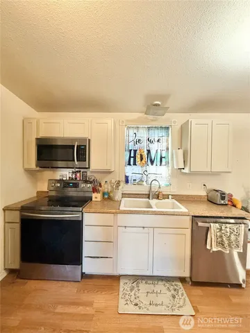 a living room with furniture and a kitchen