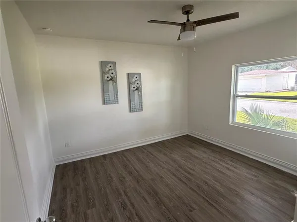 wooden floor in an empty room with a window