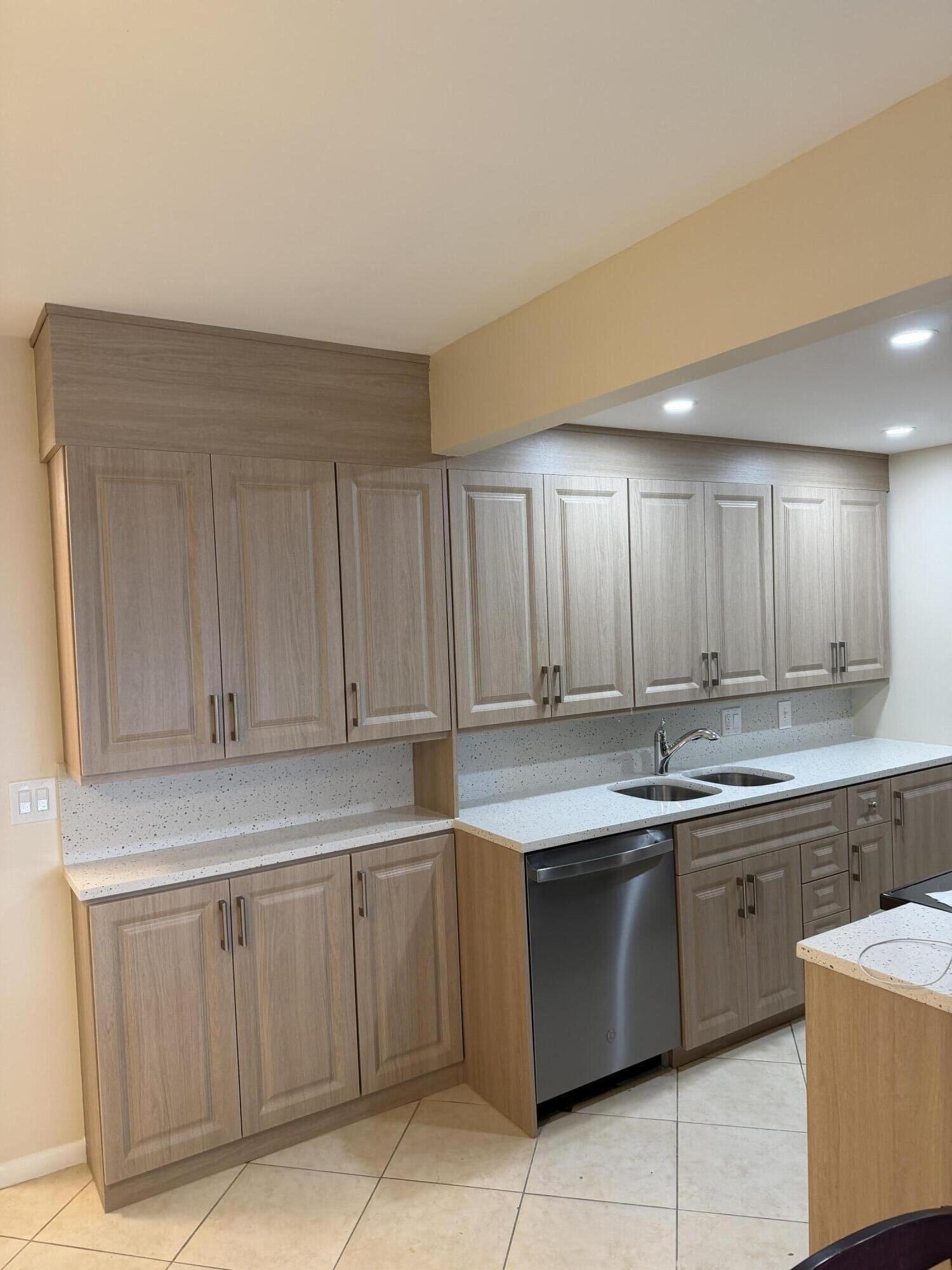 4067 Yarmouth C Boca Raton, FL 33434 - Photo 11 of 39 a kitchen with a sink and cabinets