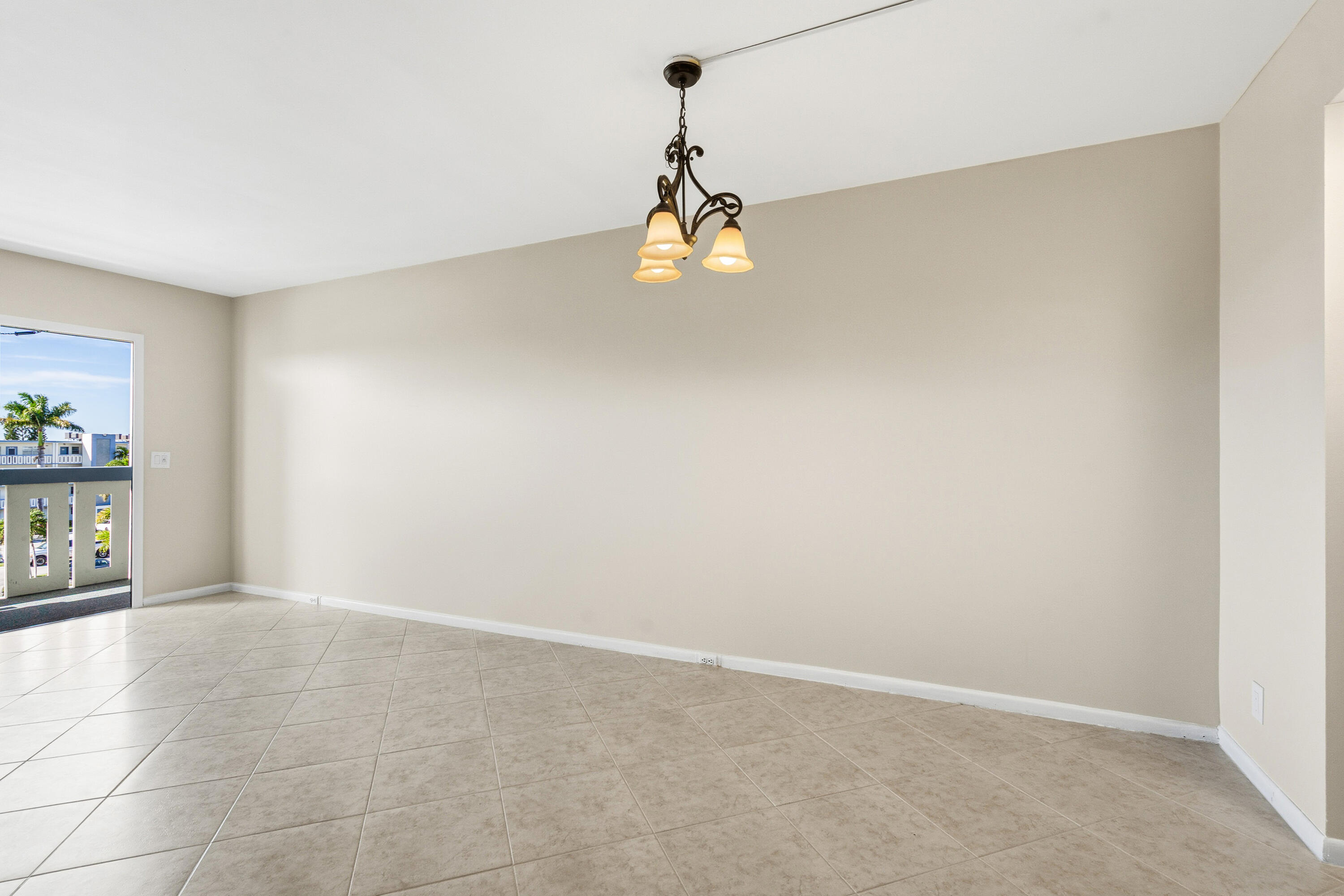 4067 Yarmouth C Boca Raton, FL 33434 - Photo 14 of 39 an empty room with painting and windows