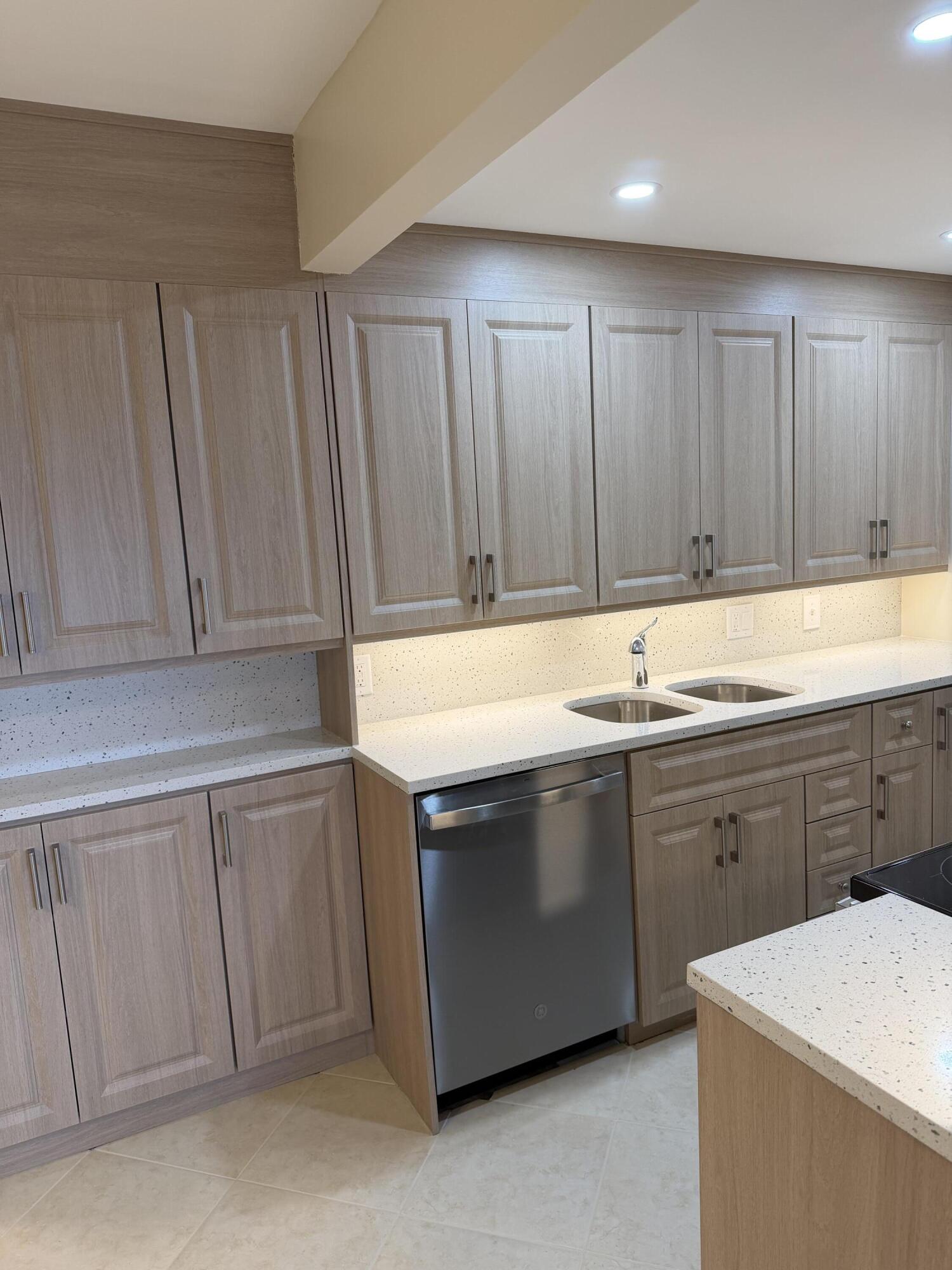 4067 Yarmouth C Boca Raton, FL 33434 - Photo 16 of 39 a kitchen with stainless steel appliances granite countertop a sink and a stove