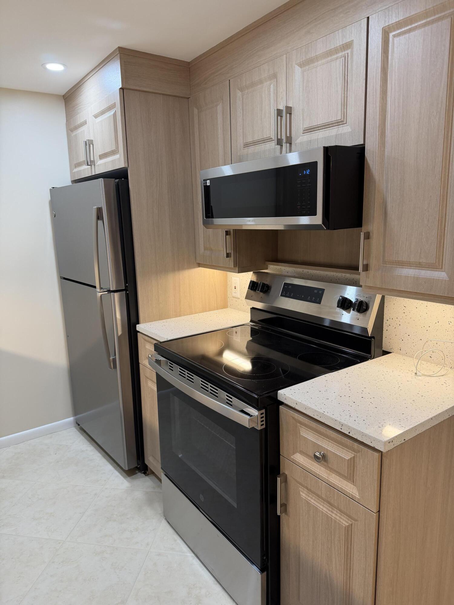 4067 Yarmouth C Boca Raton, FL 33434 - Photo 17 of 39 a kitchen with a stove and a refrigerator