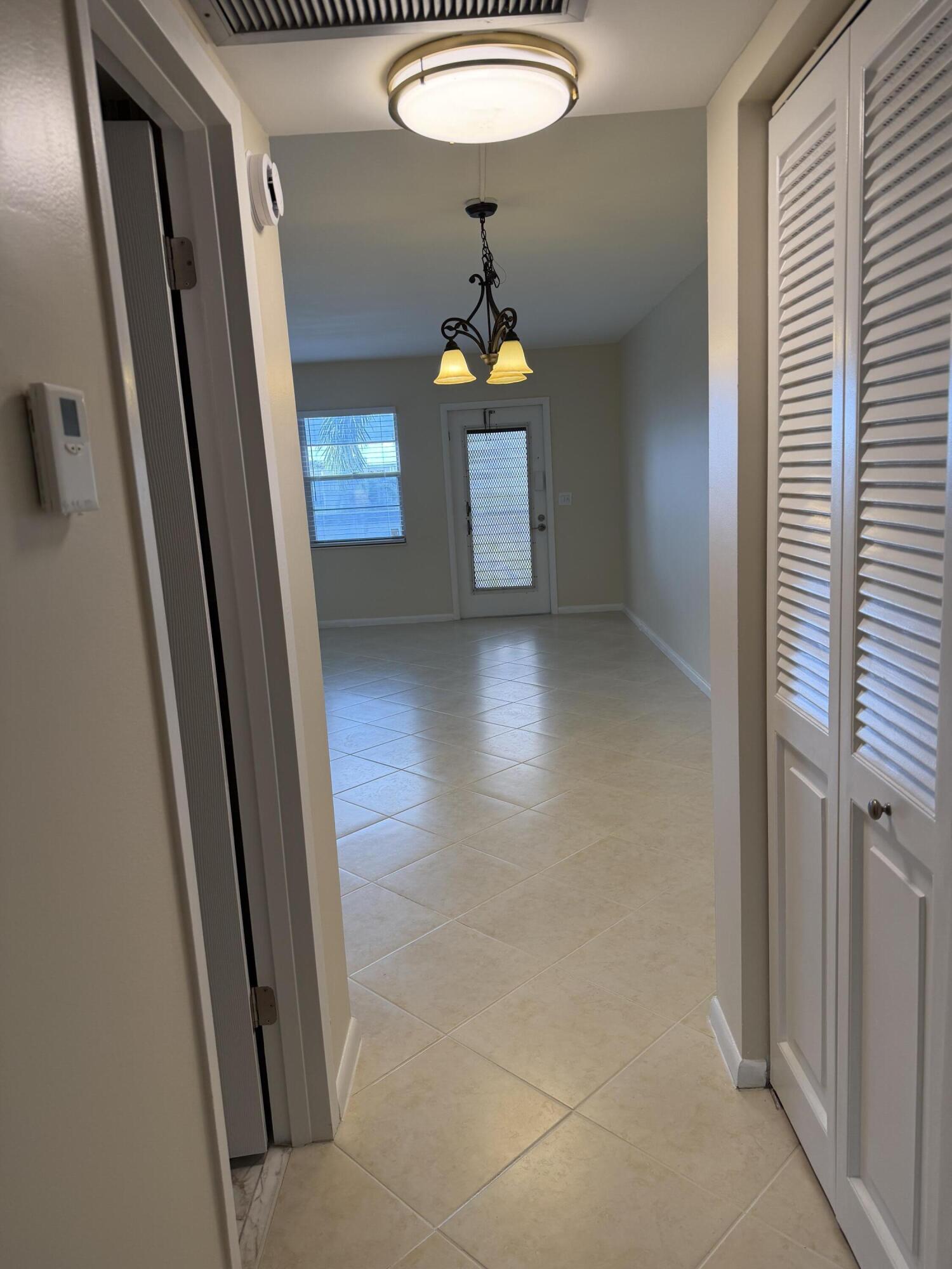 4067 Yarmouth C Boca Raton, FL 33434 - Photo 26 of 39 a room with a mirror and a fan