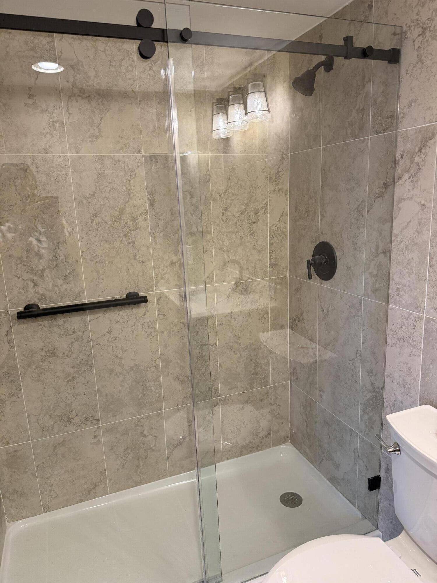 4067 Yarmouth C Boca Raton, FL 33434 - Photo 27 of 39 a bathroom with a shower and toilet