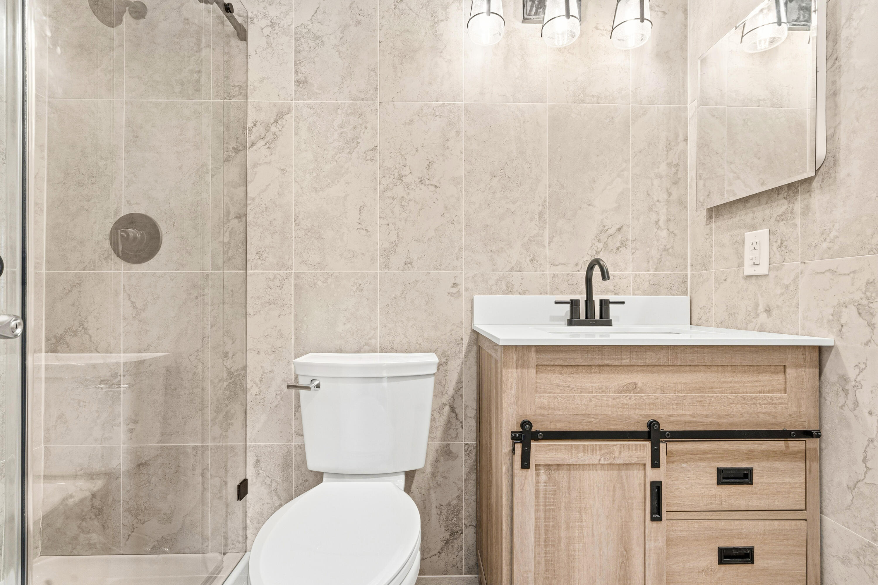 4067 Yarmouth C Boca Raton, FL 33434 - Photo 33 of 39 a bathroom with a toilet sink and shower