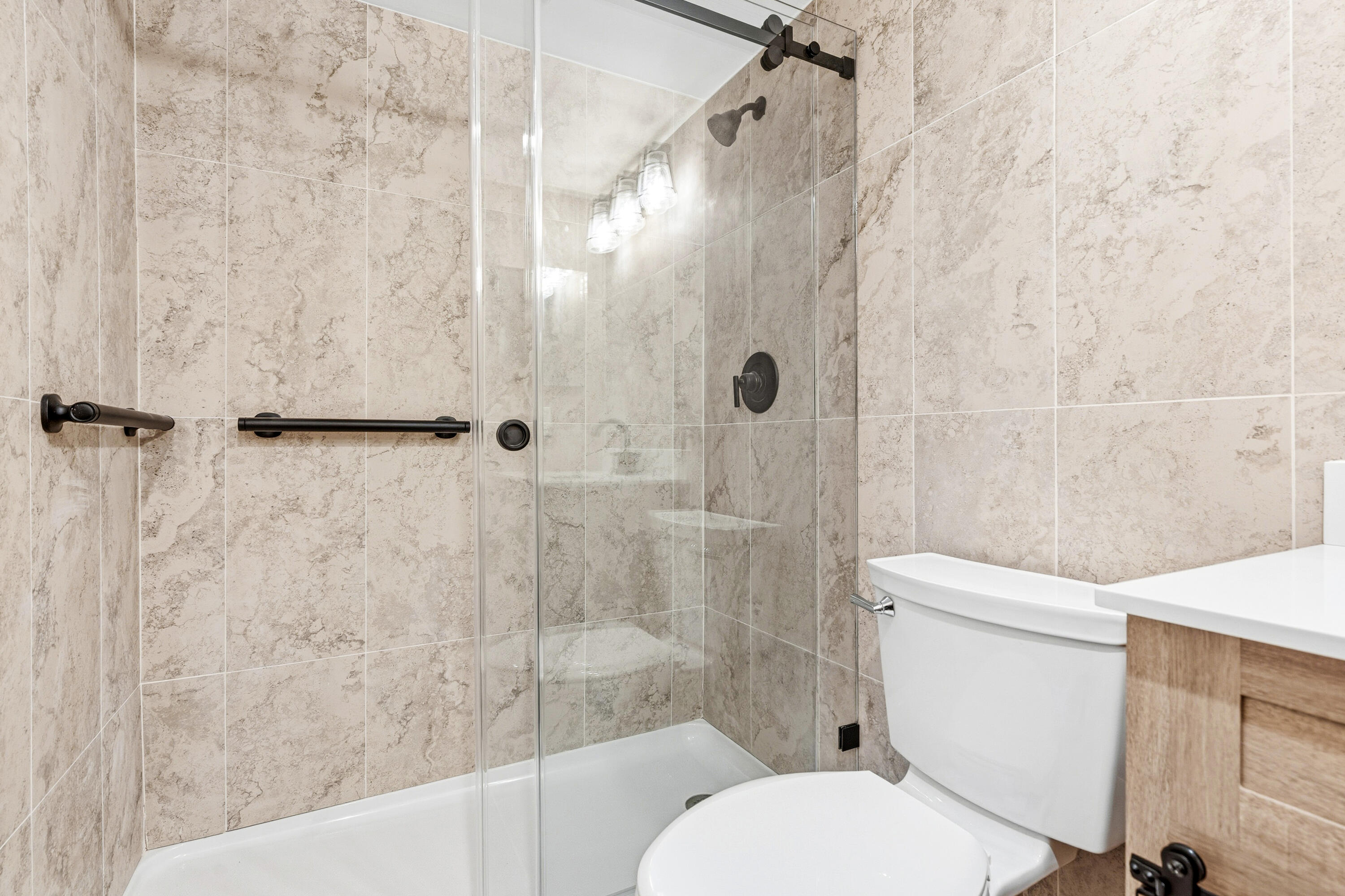 4067 Yarmouth C Boca Raton, FL 33434 - Photo 34 of 39 a white toilet sitting next to a bath tub and shower