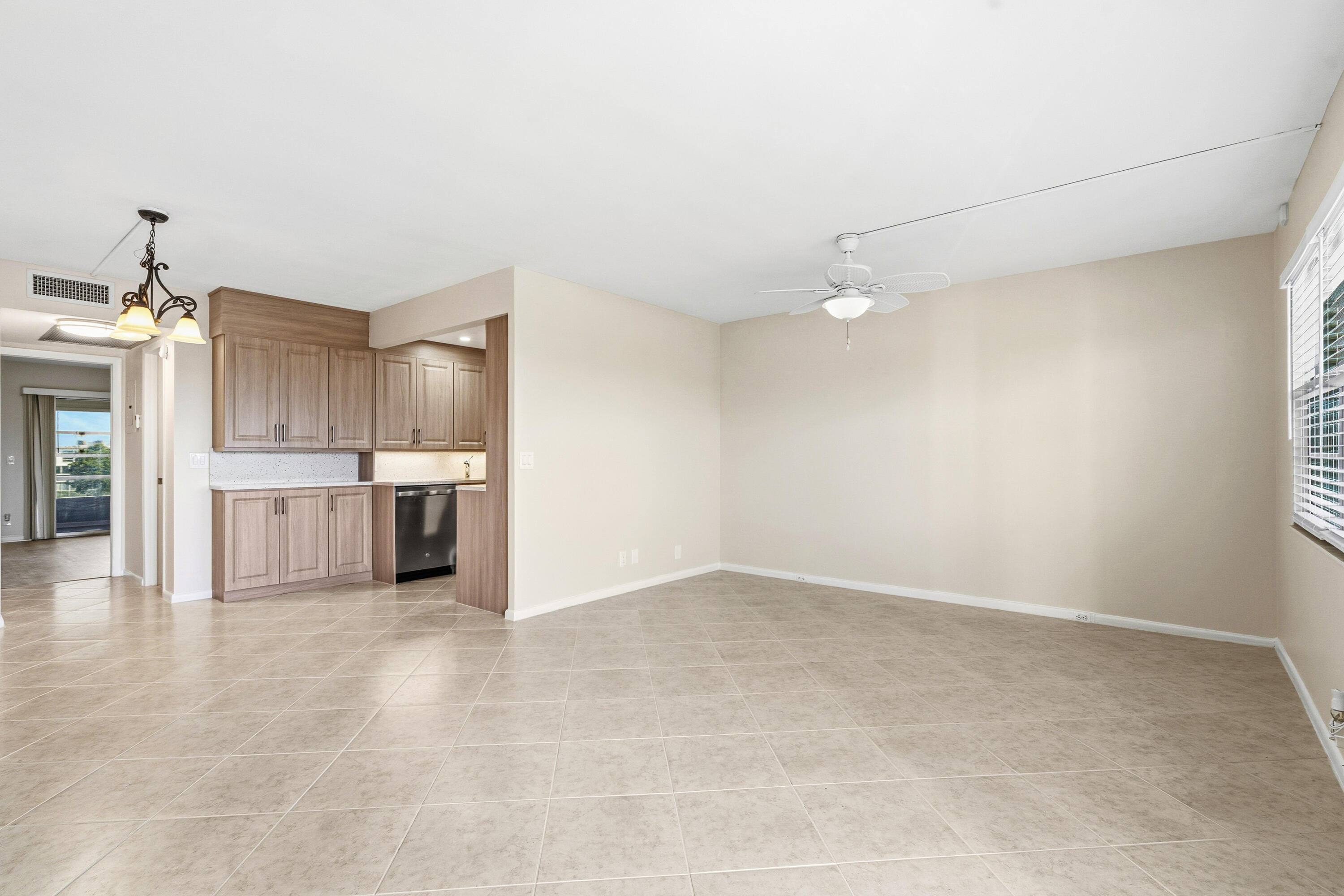 4067 Yarmouth C Boca Raton, FL 33434 - Photo 10 of 39 a view of a kitchen with refrigerator and white cabinets