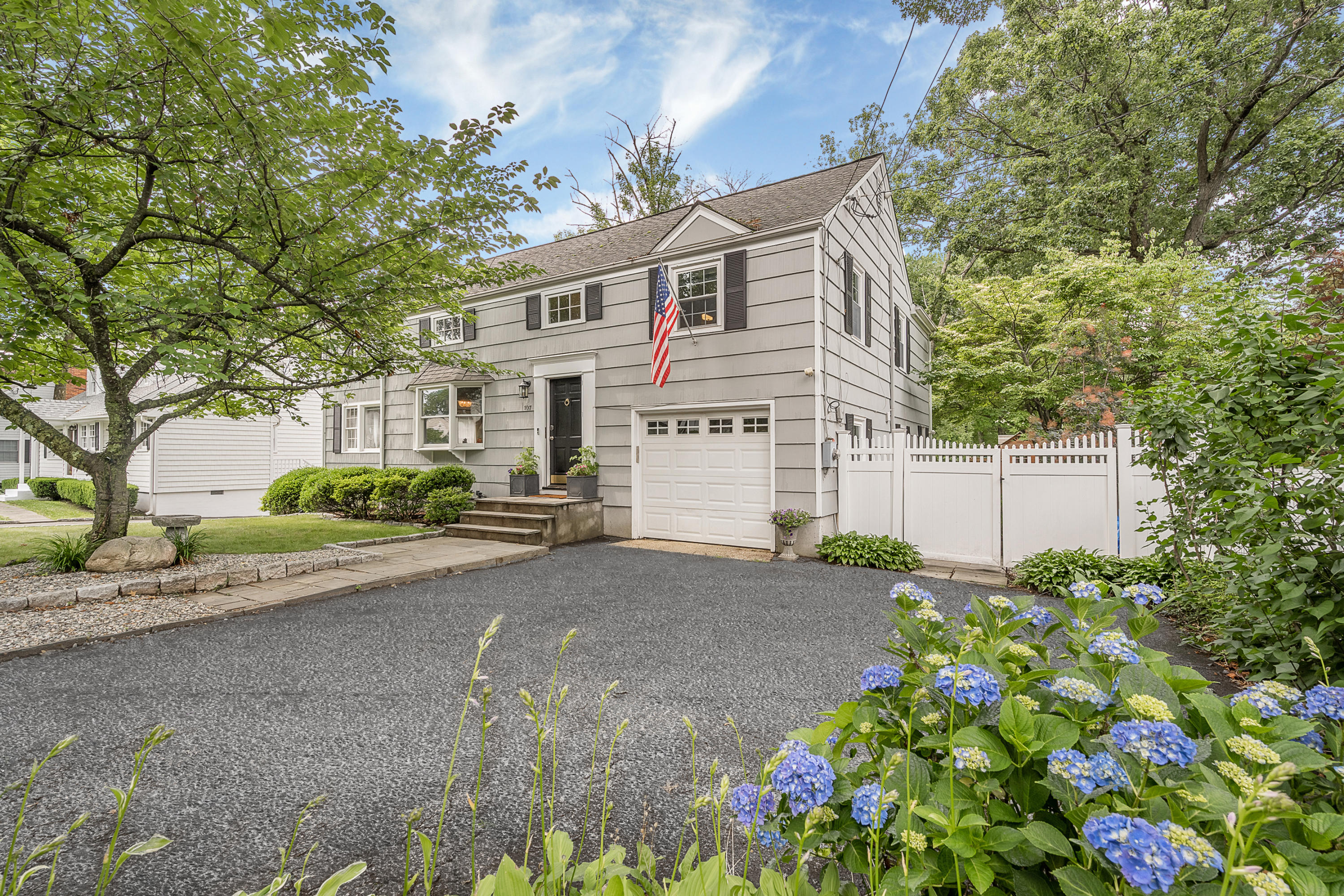 107 Hollow Tree Ridge Road Darien, CT 06820 - Photo 2 of 32 a view of a white house with a yard and plant
